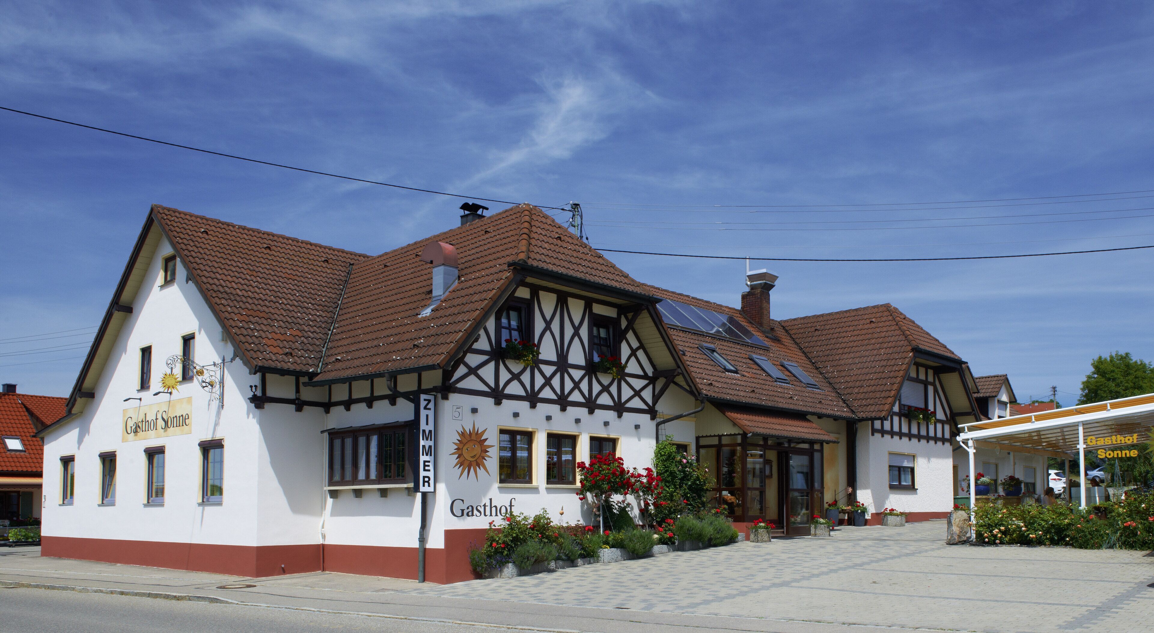 A traditional half-timbered building with a sign reading "Gasthof Sonne".