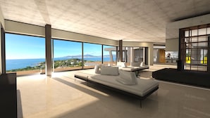 Un intérieur moderne avec de grandes fenêtres, un design minimaliste et une vue sur la mer.
