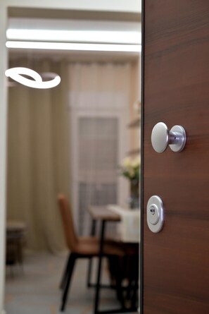 A wooden door with a modern handle and a keyhole.