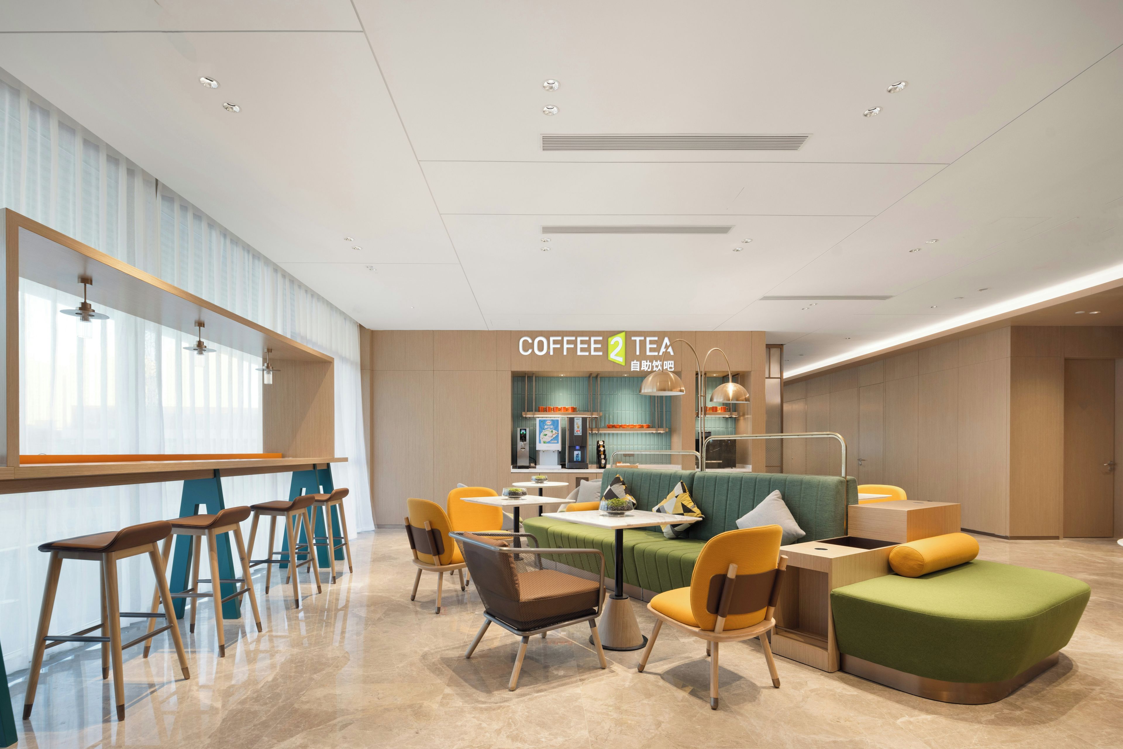 A modern coffee shop interior with seating arrangements, a counter, and a visible menu board.