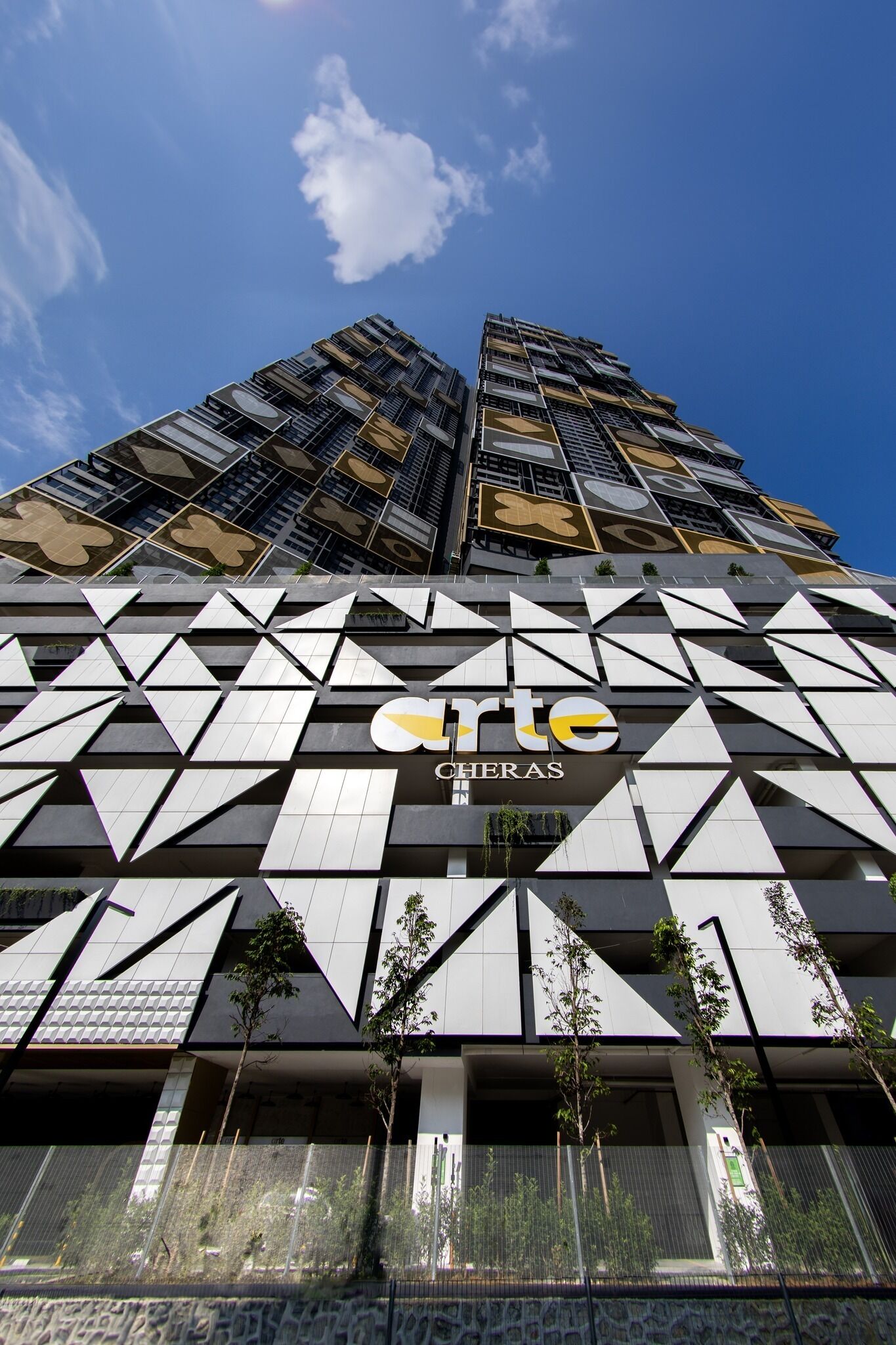Un bâtiment moderne doté d’une façade géométrique et d’un logo bien visible.