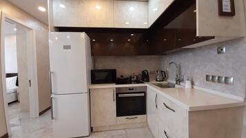 Panoramic Apartment | Private kitchen | Full-sized fridge, microwave, oven, toaster