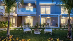 A modern two-story building with a balcony, outdoor seating, and a well-maintained lawn. - Anastasia Residential Complex (Pangaio)