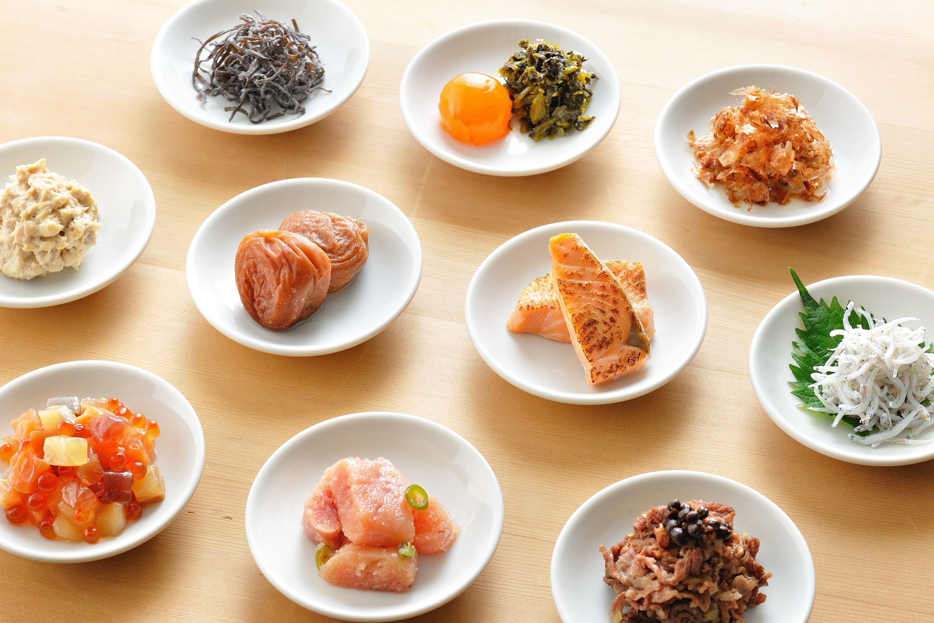 A variety of small dishes arranged on a wooden table.