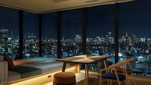 A modern interior with a city view, a sofa, a table, and chairs. - OMO5 Tokyo Gotanda by Hoshino Resorts (Tokyo)