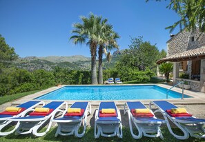 A pool with lounge chairs and a stone building. - VILLA PICASA ALT - SURROUNDED BY NATURE (Pollensa)