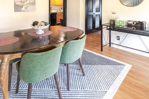 A dining area with a round table, two chairs, and a decorative bowl on the table. - Trailside Retreat in the City (Tulsa)