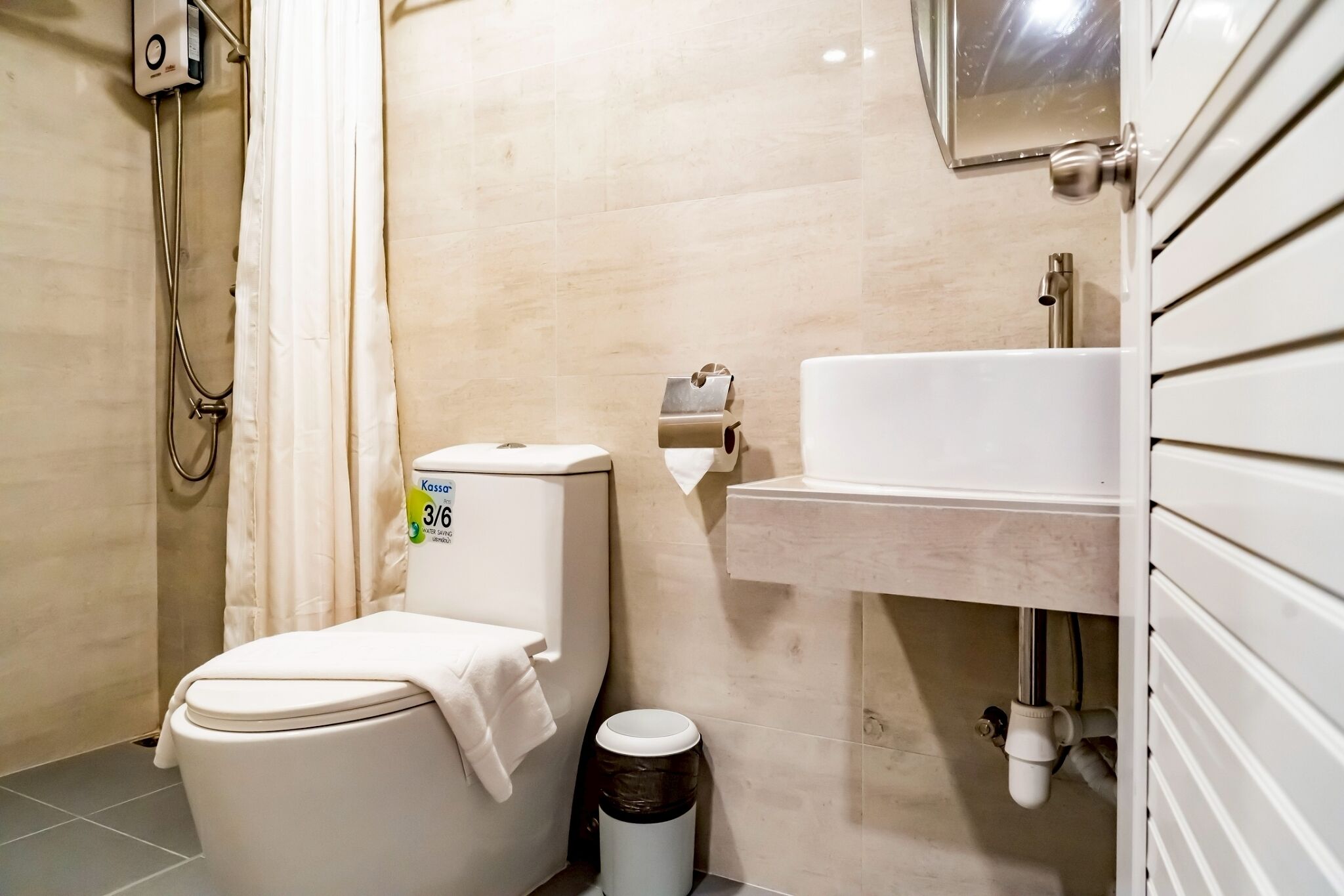 A compact bathroom with a toilet, bidet, and sink.