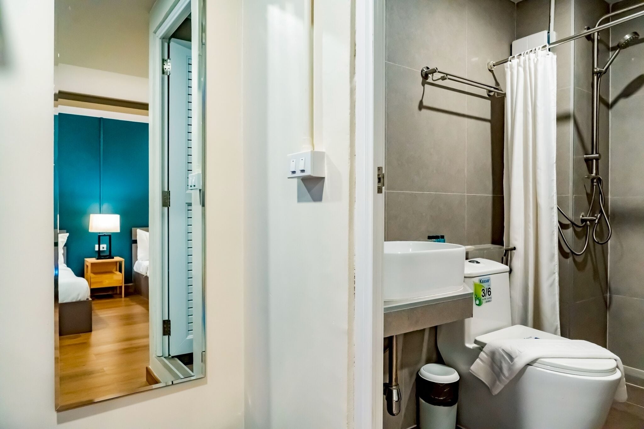 A modern bathroom with a shower, toilet, and sink.