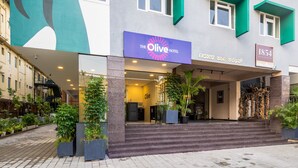 The Olive Hotel with a modern facade, a staircase leading to the entrance, and a coffee collection named 1854. - Olive Hotel JP Nagar by Embassy Group (Bengaluru)