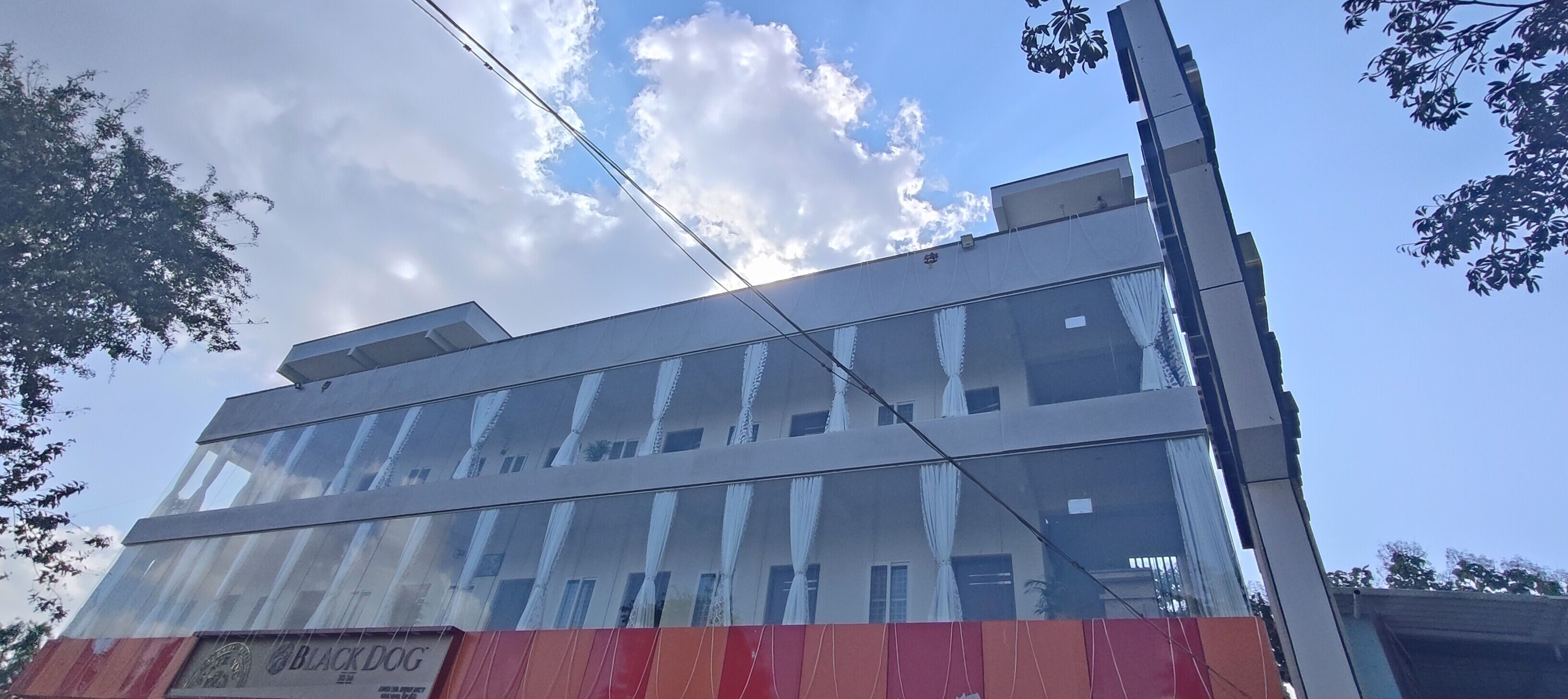 A modern building with multiple floors and large windows.