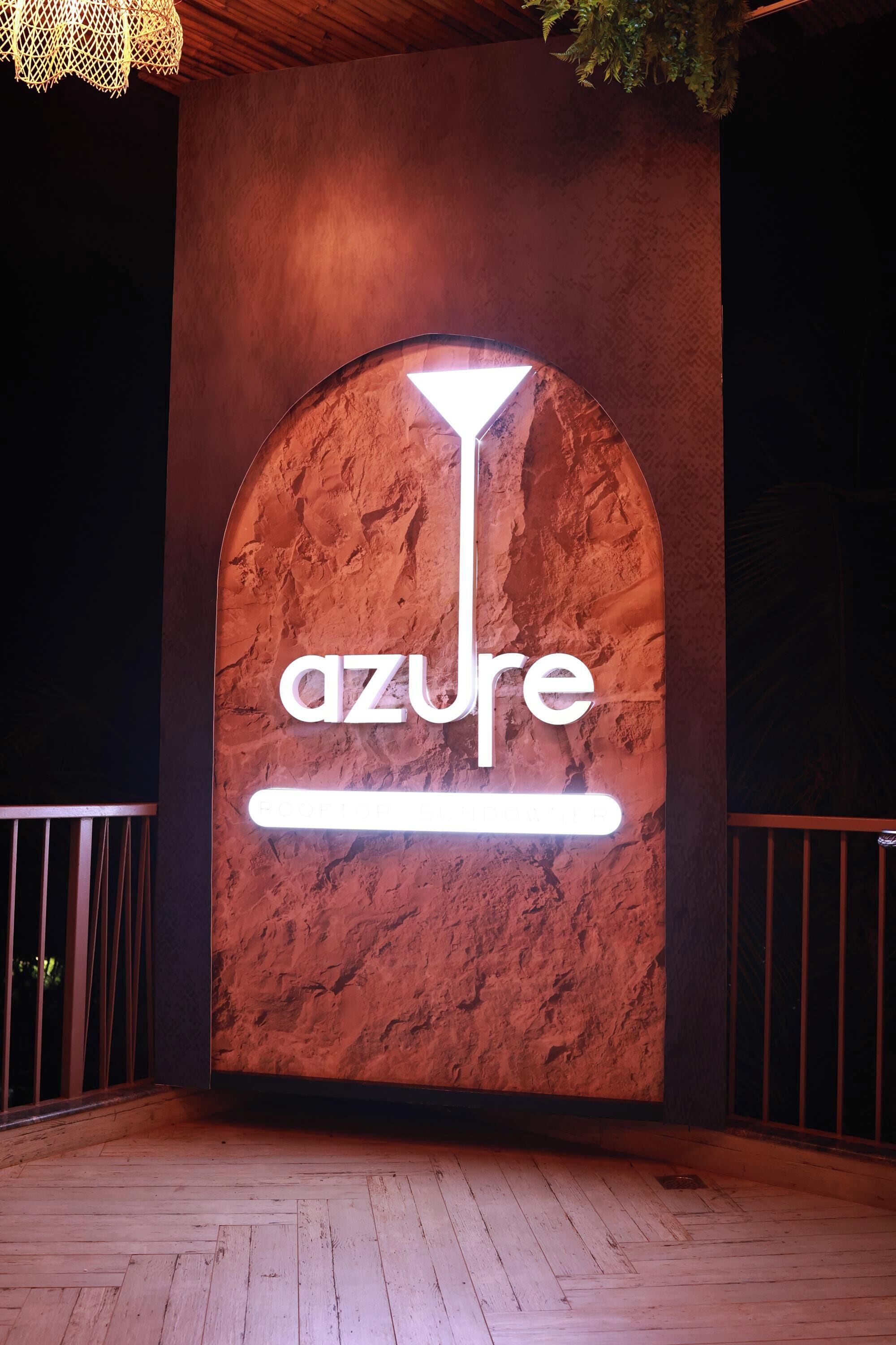 A sign with the word 'azure' on a textured wall.