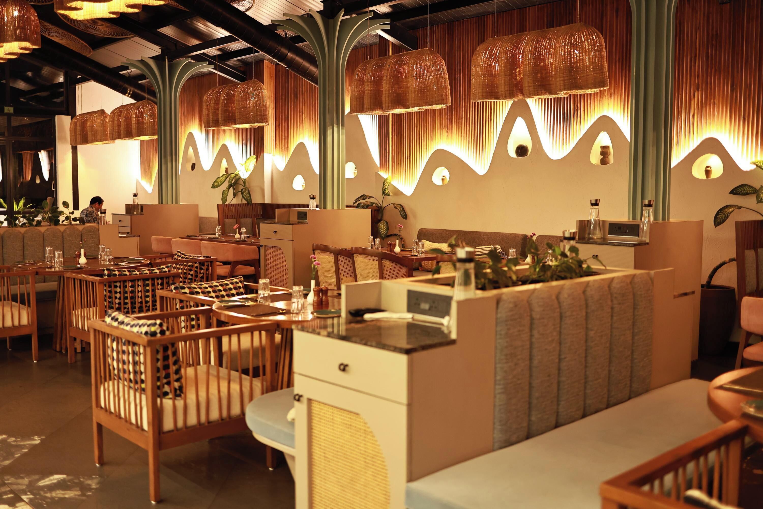 A restaurant interior with wooden furniture, woven light fixtures, and a modern design.