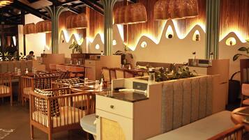 A restaurant interior with wooden furniture, woven light fixtures, and a modern design.