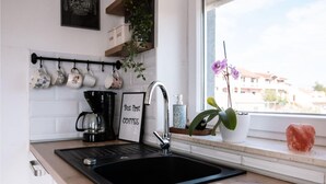 A kitchen with a black sink, coffee maker, and a sign that says "But first COFFEE". - Stunning home in Sibenik (Sibenik)