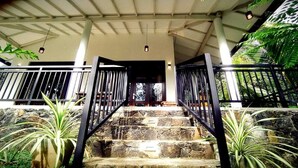 A stone staircase with metal railings leading to a covered entrance. - White Villa (Tangalle)