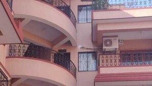 A multi-story residential building with balconies, a staircase, and a swimming pool. - Signum Court (Calangute)