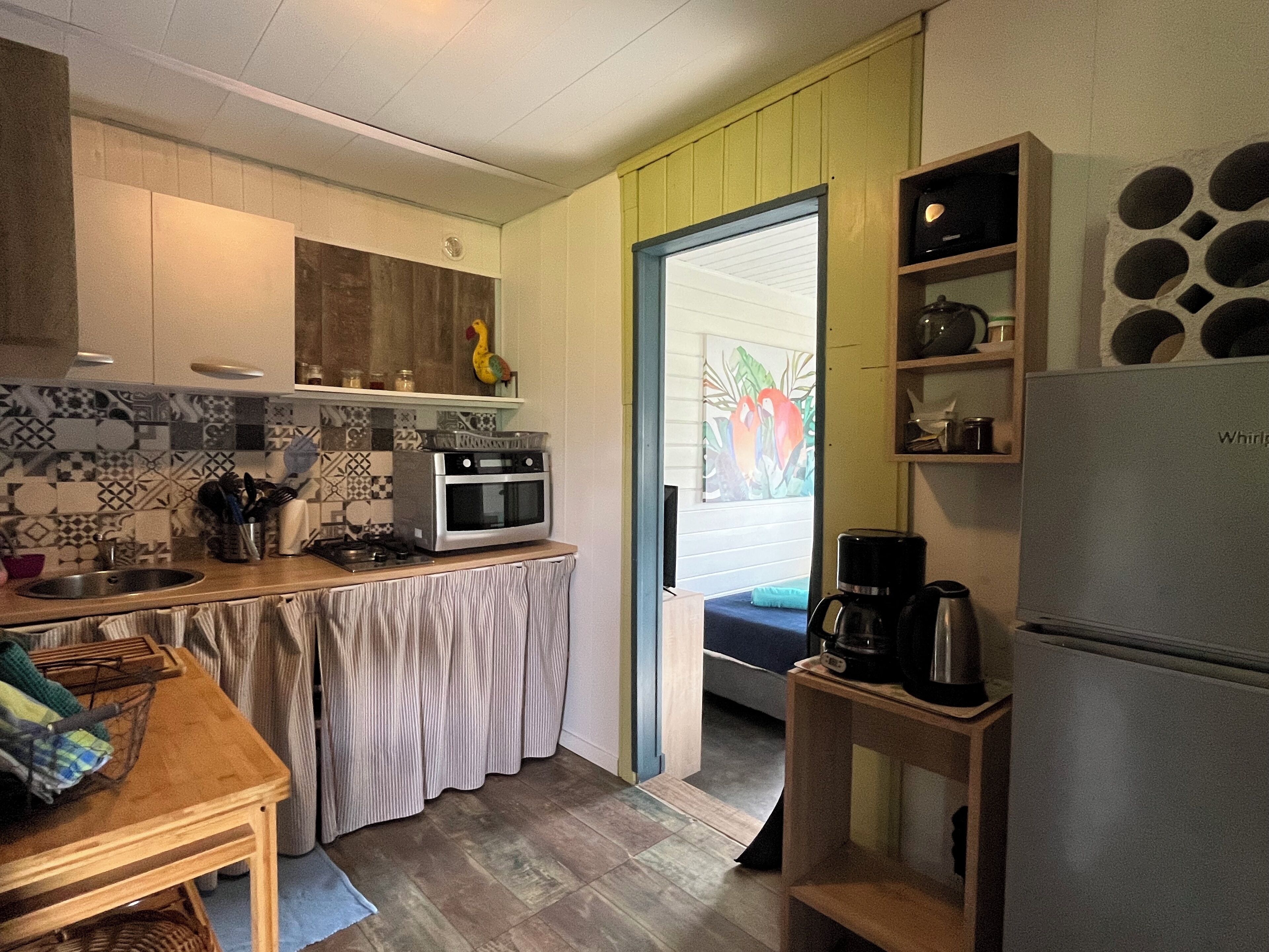 A kitchen with a stove, oven, and coffee maker.
