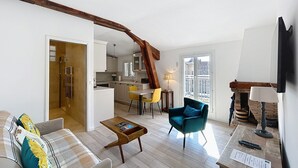 A modern apartment with a living room, kitchen, and dining area. There is a staircase leading to an upper floor. - 2 bedrooms with terrace 1 minute from the Palais Cannes Croisette Apartment (Cannes)