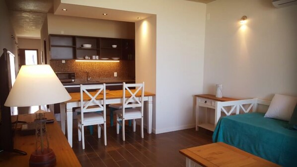 A compact living space with a kitchenette, a dining area, and a bed. - THE BEACH La Paloma  (La Paloma)