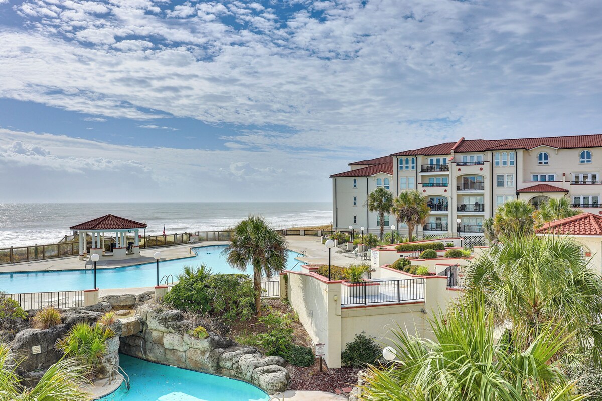 A resort with a pool, a gazebo, and a view of the ocean.