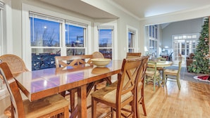 A dining area with a wooden table and chairs, large windows, and a Christmas tree. - 6 Mi to Bourbon Trail: Group Estate on 20 Acres (Shelbyville)