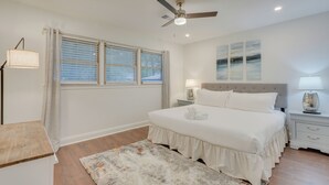 A bedroom with a bed, nightstands, a ceiling fan, and a window with blinds. - North Charleston Escape ~ 15 Mi to Dtwn Charleston (North Charleston)