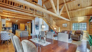 A spacious log cabin interior with a large dining table, multiple seating areas, and a staircase leading to an upper level. - 4 Mi to Rocky Mtn Nat'l Park: Cabin Near Town! (Grand Lake)