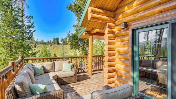 A log cabin with a deck featuring wicker furniture and a glass door. - 4 Mi to Rocky Mtn Nat'l Park: Cabin Near Town! (Grand Lake)