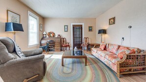 A living room with a sofa, armchairs, a coffee table, and a fireplace. - Altmar Vacation Rental ~ 4 Mi to Salmon River! (Parish)