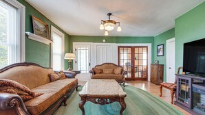 A living room with a sofa, a coffee table, and a television. - Altmar Vacation Rental ~ 4 Mi to Salmon River! (Parish)