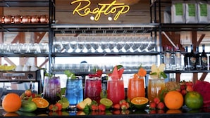 A bar area with a neon sign reading "A&P Ristorante" and various colorful cocktails displayed on the counter. - Hera Boutique Hotel (Xuan Huong - Da Lat)