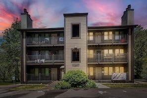A multi-story residential building with balconies, a central entrance, and a sign indicating 'Building C Units 13-18.' - C14 Gore Creek Meadows 3 Bedroom Condo by RedAwning (Vail)