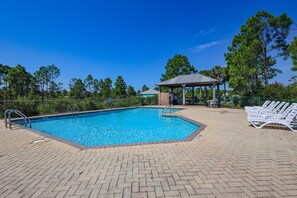 A swimming pool with a gazebo and lounge chairs. - The Rookery Iii 5001 3 Bedroom Cottage by RedAwning (Gulf Shores)
