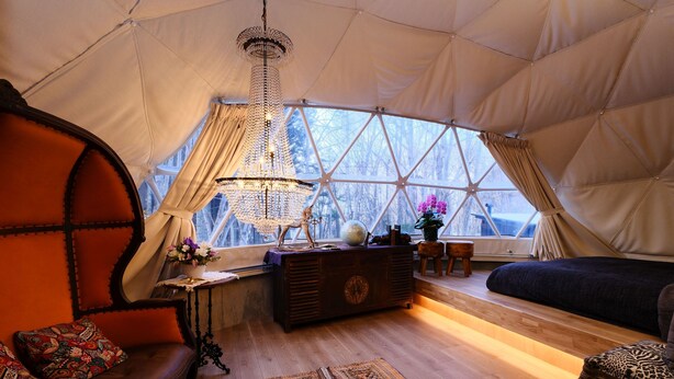 A cozy interior with a large window, a chandelier, and a sofa. - villa Fukuza (Naganuma)