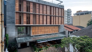 A modern building with a flat roof, large windows, and a covered outdoor seating area. - Taprobane House (Colombo)