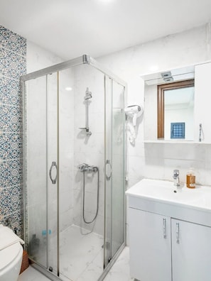 Combined shower/bathtub, designer toiletries, hair dryer, bathrobes