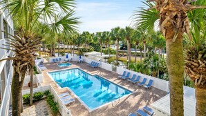 A pool area with lounge chairs and palm trees. - ☀️Beach-Pool Access-30A-Gulf Place Caribbean 311 (Santa Rosa Beach)