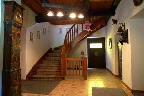 A staircase with wooden railings and carpeted steps leading to a door with a green panel. - Farmhouse in Afritz near Gerlitzen Ski Center (Afritz-Verditz)