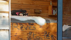 A wooden cabin interior with a wooden wall and a sign that reads "Rêves Etoiles". - DOMAINE RÊVES ETOILÉS (La Roche-Maurice)