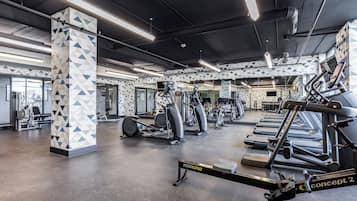 A gym with various exercise equipment, including treadmills and weight machines.