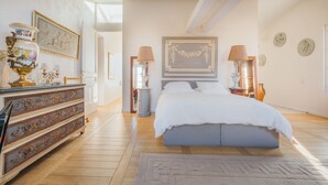 A bedroom with a bed, dresser, and decorative items. - 2 storey luxury penthouse with large terrace but no elevator (Paris)