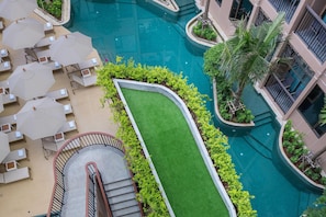 A rooftop pool area with lounge chairs and a staircase. - The Proud Karon Beach Phuket Trademark Collection By Wyndham (Karon)