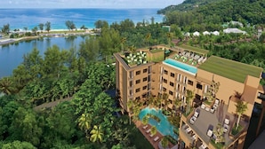 A resort with a pool, multiple floors, and a view of the ocean. - The Proud Karon Beach Phuket Trademark Collection By Wyndham (Karon)