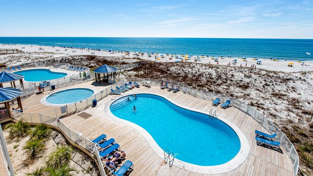 A resort with multiple swimming pools, beach access, and lounge areas. - Sugar Beach Condominiums (Orange Beach)