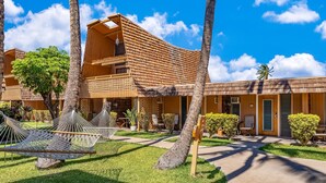 A resort with a wooden building, outdoor seating, and a hammock. - Vacasa at Hotel Molokai (Kaunakakai)