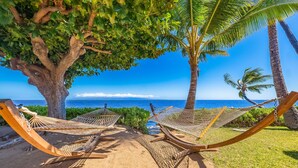 Two hammocks under a tree with a view of the ocean. - Vacasa at Hotel Molokai (Kaunakakai)