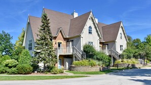 A large, two-story house with a prominent front porch, multiple windows, and a well-maintained lawn. - Snowbridge (The Blue Mountains)