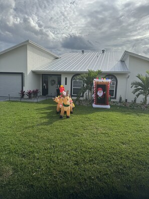 A house with a garage, a front door, and a mailbox. - JUST IN TIME FOR SEASON! (Bonita Springs)