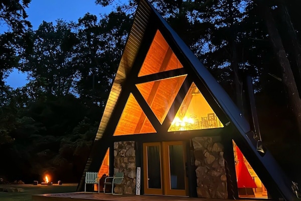 Spacious A-frame nestled within expansive grounds, offering abundant outdoor space